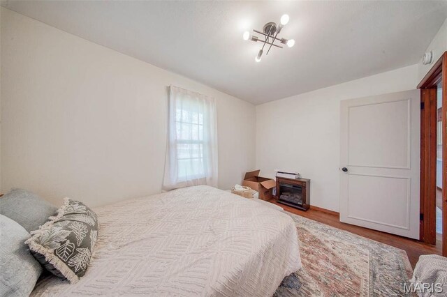 1003 S Warfel St, Salem, MO 65560 - bedroom with wood finished floors and a chandelier