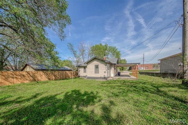 1003 S Warfel St, Salem, MO 65560 - back of house featuring a chimney and a carport