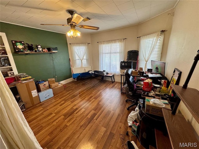 office area with wood finished floors, a ceiling fan, and crown molding