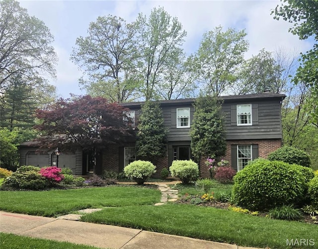 14590 Ansonborough Ct, Chesterfield, MO 63017 - view of front of house with brick siding, a front yard, and a garage