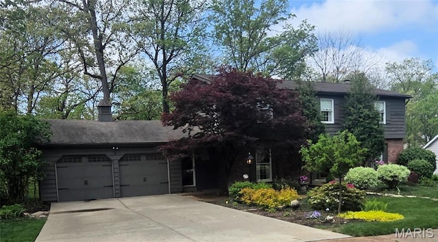 14590 Ansonborough Ct, Chesterfield, MO 63017 - view of front of house with a garage, concrete driveway, and brick siding