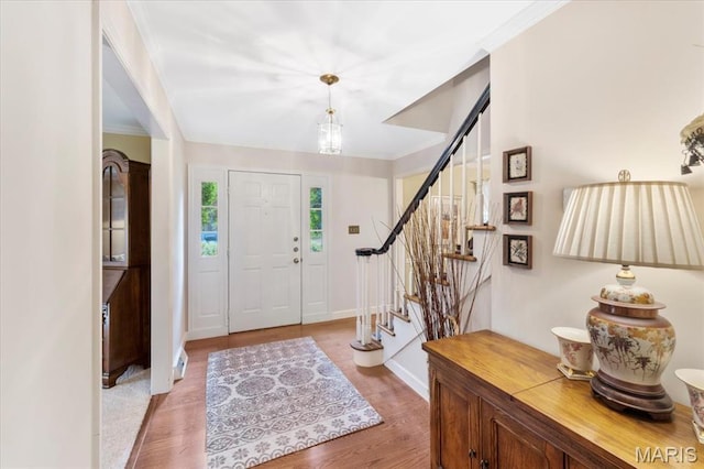14590 Ansonborough Ct, Chesterfield, MO 63017 - entrance foyer with stairs, light wood finished floors, ornamental molding, and baseboards