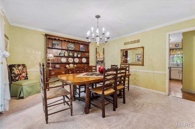 14590 Ansonborough Ct, Chesterfield, MO 63017 - dining space featuring a chandelier, crown molding, and baseboards