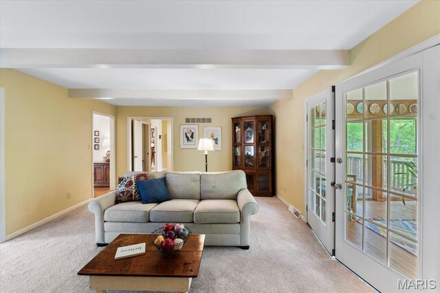 14590 Ansonborough Ct, Chesterfield, MO 63017 - living room featuring beam ceiling, french doors, light carpet, and baseboards