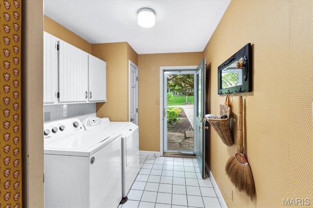 14590 Ansonborough Ct, Chesterfield, MO 63017 - laundry area featuring separate washer and dryer, cabinet space, baseboards, and light tile patterned floors