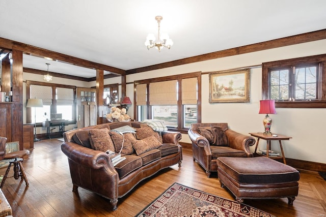 living room with a chandelier, baseboards, beam ceiling, and wood finished floors
