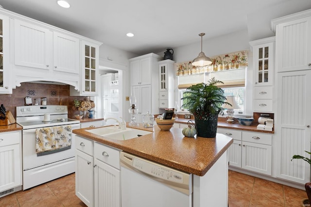 kitchen with white appliances, a sink, white cabinetry, light tile patterned floors, and recessed lighting