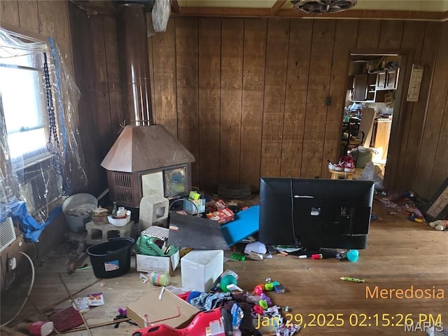 514 NW Washington St, Meredosia, IL 62665 - bedroom with wooden walls, a wood stove, and wood finished floors