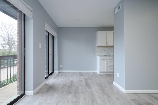 572 Coeur De Royale Dr Unit 108, Saint Louis, MO 63141 - unfurnished living room with light wood-style flooring and baseboards