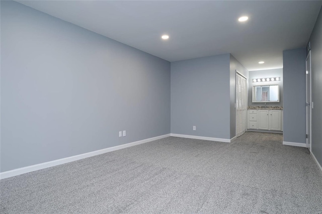 572 Coeur De Royale Dr Unit 108, Saint Louis, MO 63141 - unfurnished bedroom with dark colored carpet, recessed lighting, baseboards, ensuite bathroom, and a sink