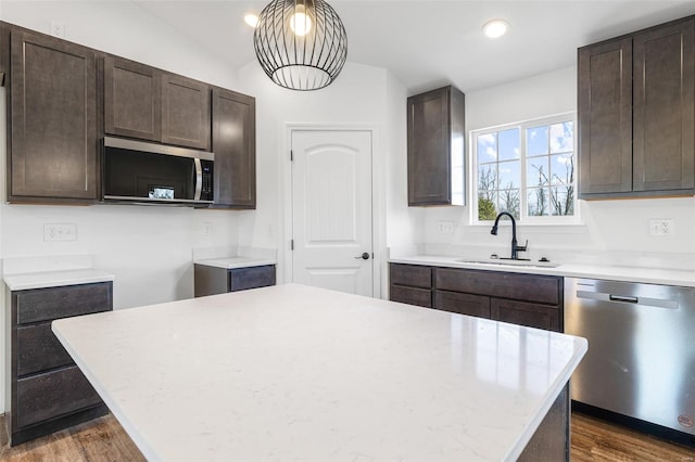 308 Blackberry Ln, Bismarck, MO 63624 - kitchen with appliances with stainless steel finishes, a sink, dark brown cabinetry, recessed lighting, and lofted ceiling