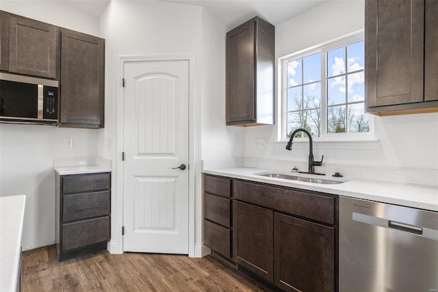 308 Blackberry Ln, Bismarck, MO 63624 - kitchen featuring stainless steel appliances, a sink, dark brown cabinets, wood finished floors, and light countertops