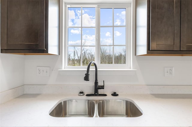 308 Blackberry Ln, Bismarck, MO 63624 - kitchen view of a sink, dark brown cabinets, and light stone countertops