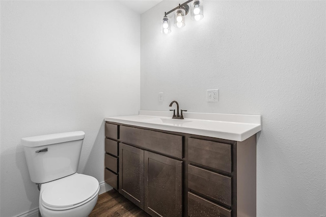 308 Blackberry Ln, Bismarck, MO 63624 - half bathroom with wood finished floors, toilet, baseboards, and vanity