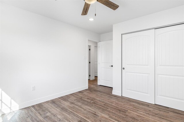 308 Blackberry Ln, Bismarck, MO 63624 - unfurnished bedroom with wood finished floors, baseboards, recessed lighting, a closet, and a ceiling fan