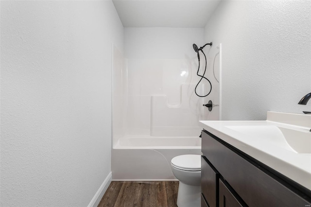 308 Blackberry Ln, Bismarck, MO 63624 - bathroom with wood finished floors, toilet, vanity, washtub / shower combination, and baseboards