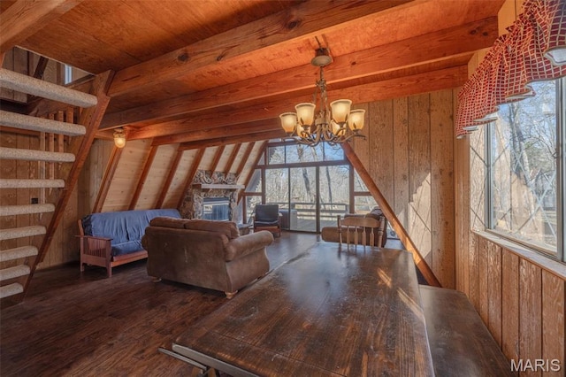 756 E St Gallen Dr, Innsbrook, MO 63390 - living area featuring stairway, a chandelier, wooden walls, wood finished floors, and a stone fireplace
