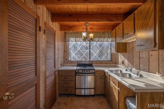 756 E St Gallen Dr, Innsbrook, MO 63390 - kitchen with stainless steel range with electric cooktop, a sink, light countertops, wooden walls, and brown cabinets