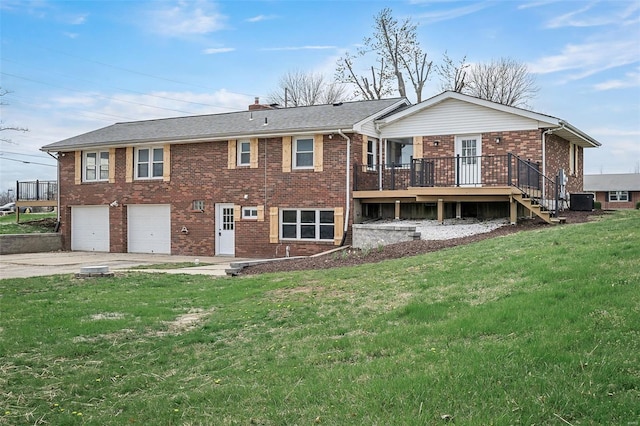 4 Tiger Dr, Wentzville, MO 63385 - back of property featuring brick siding, a garage, a deck, concrete driveway, and a yard
