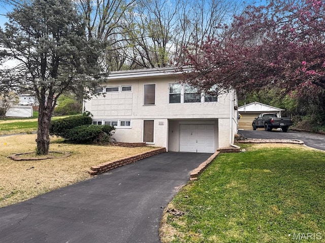 404 Hillside Dr, Collinsville, IL 62234 - view of front facade with asphalt driveway, an attached garage, a front yard, and stucco siding