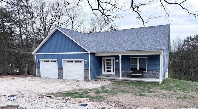 1564 Mandy Ln, Barnhart, MO 63012 - view of front facade featuring stone siding, an attached garage, and a shingled roof
