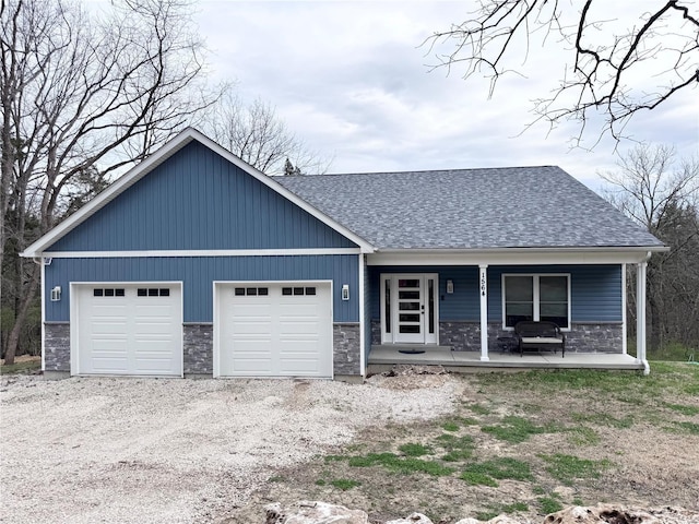 1564 Mandy Ln, Barnhart, MO 63012 - view of front of house with a porch, driveway, stone siding, and a shingled roof