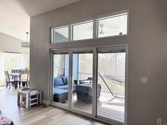 1564 Mandy Ln, Barnhart, MO 63012 - entryway featuring light wood-type flooring, lofted ceiling, baseboards, and a chandelier