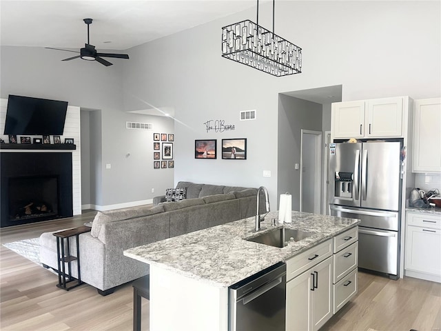 1564 Mandy Ln, Barnhart, MO 63012 - kitchen featuring appliances with stainless steel finishes, high vaulted ceiling, a sink, a ceiling fan, and open floor plan