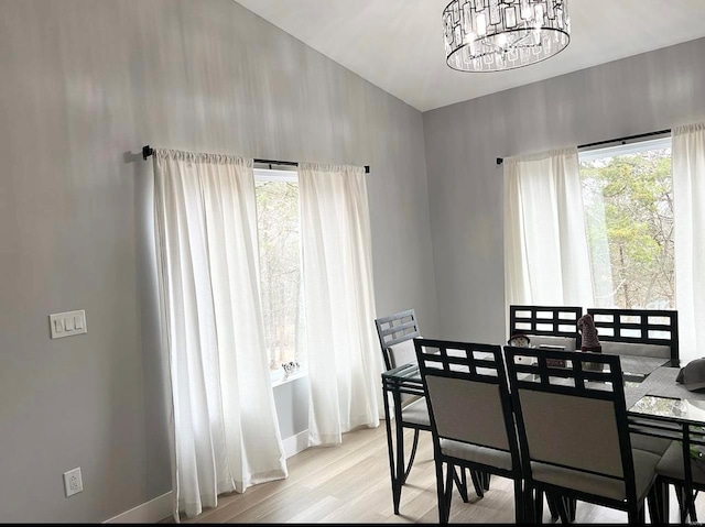 1564 Mandy Ln, Barnhart, MO 63012 - dining space featuring a chandelier, healthy amount of natural light, wood finished floors, and baseboards