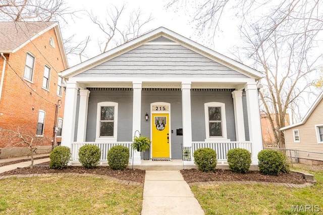 neoclassical / greek revival house with covered porch and a front yard