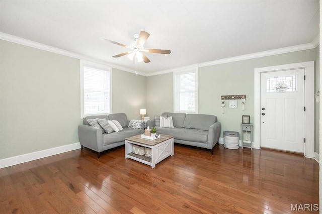 living area with crown molding, wood finished floors, baseboards, and a ceiling fan