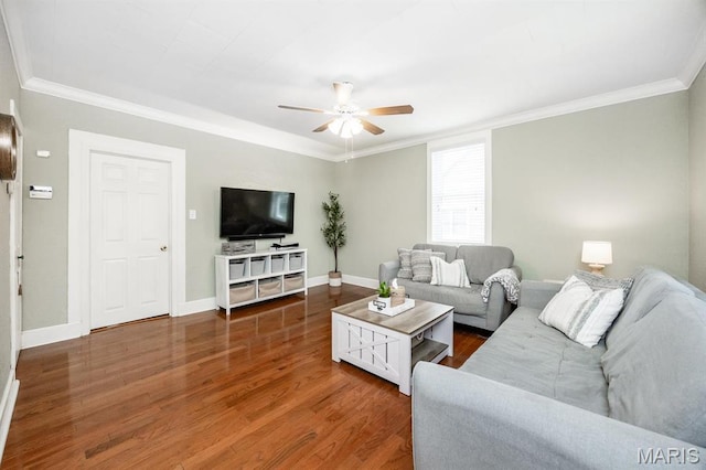 living area with a ceiling fan, ornamental molding, wood finished floors, and baseboards