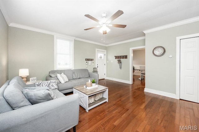 living area with ornamental molding, a ceiling fan, baseboards, and wood finished floors
