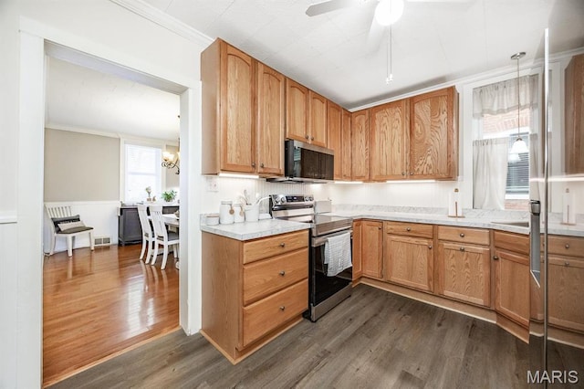 kitchen featuring appliances with stainless steel finishes, dark wood-style flooring, light countertops, wainscoting, and ceiling fan