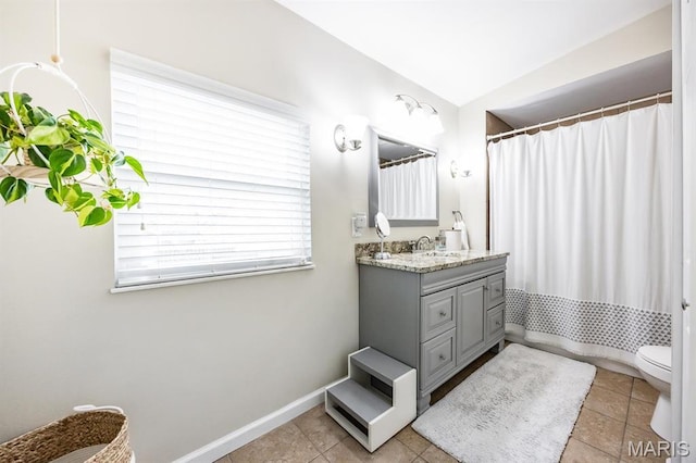 bathroom featuring vanity, toilet, tile patterned floors, baseboards, and a shower with shower curtain