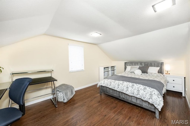 bedroom featuring lofted ceiling, wood finished floors, and baseboards