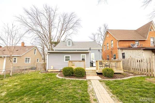 rear view of house featuring a wooden deck