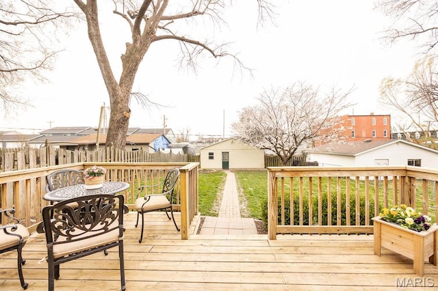 wooden terrace featuring an outdoor structure and a residential view