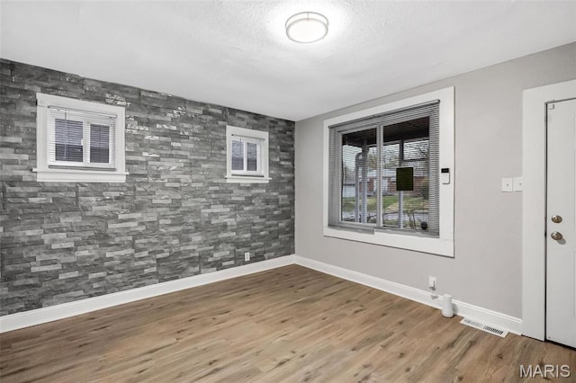 5537 Helen Ave, Saint Louis, MO 63136 - unfurnished room featuring baseboards, wood finished floors, and a textured ceiling