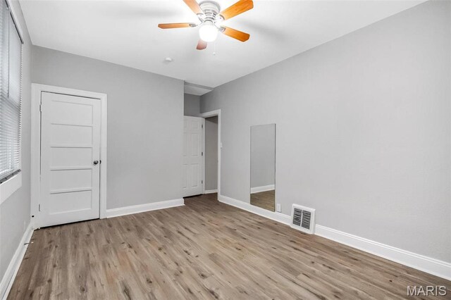 5537 Helen Ave, Saint Louis, MO 63136 - unfurnished bedroom featuring baseboards, wood finished floors, and a ceiling fan
