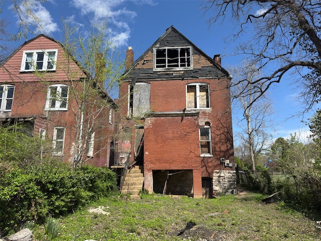 5674 Cabanne Ave, Saint Louis, MO 63112 - back of property featuring a chimney, stairs, and brick siding