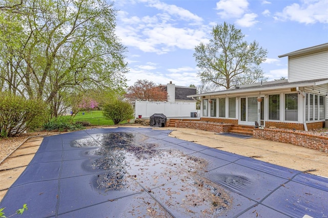 29 Park Charles Blvd N, Saint Peters, MO 63376 - view of pool featuring a sunroom, fence, a patio, entry steps, and a covered pool