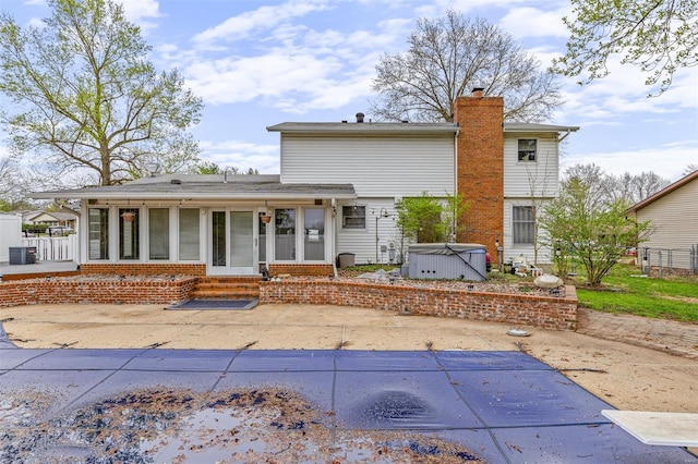 29 Park Charles Blvd N, Saint Peters, MO 63376 - view of front of home featuring a hot tub, a chimney, a sunroom, entry steps, and a patio area
