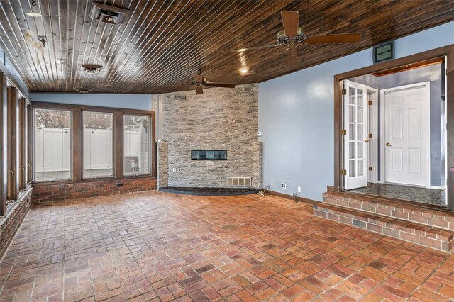 29 Park Charles Blvd N, Saint Peters, MO 63376 - unfurnished living room with a ceiling fan, baseboards, brick floors, and a stone fireplace