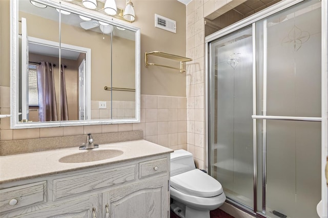 29 Park Charles Blvd N, Saint Peters, MO 63376 - bathroom featuring tile walls, a stall shower, toilet, and vanity