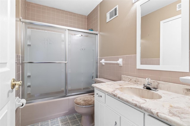29 Park Charles Blvd N, Saint Peters, MO 63376 - full bath with toilet, shower / bath combination with glass door, vanity, and tile walls