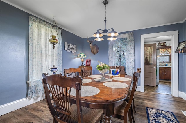 8 Donald St, Park Hills, MO 63601 - dining area featuring a chandelier, wood finished floors, crown molding, and baseboards