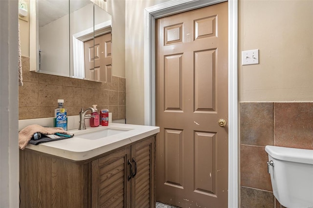 8 Donald St, Park Hills, MO 63601 - half bathroom with tile walls, toilet, vanity, and a wainscoted wall
