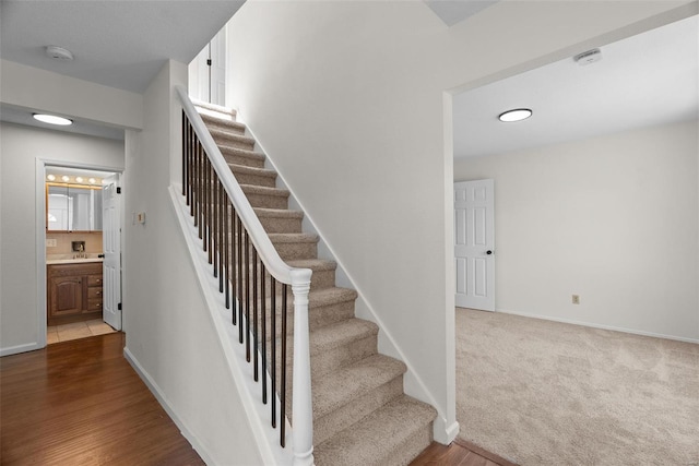 7 Beavertail Ct, Florissant, MO 63033 - stairs featuring baseboards and wood finished floors