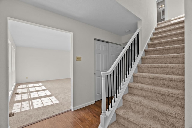 7 Beavertail Ct, Florissant, MO 63033 - staircase featuring wood finished floors and baseboards